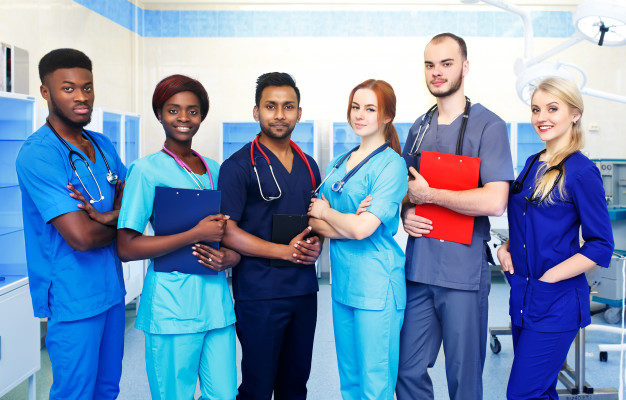 multiracial-team-young-doctors-hospital-standing-operating-room_132024-679